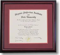 A Virginia Tech diploma in a dark wood moulding with a maroon mat.